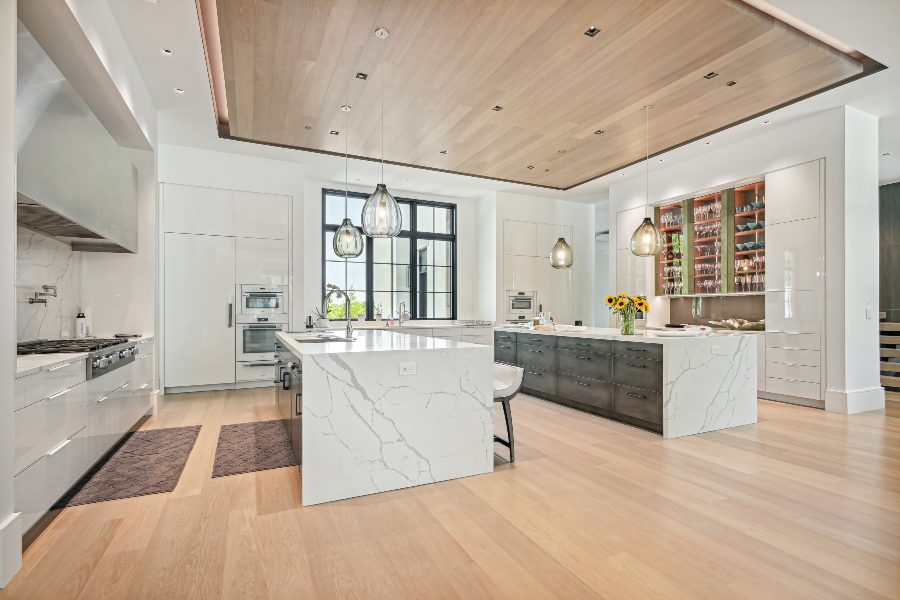 White marble contemporary kitchen area, Lutron lighting controls, hardwood ceiling and flooring