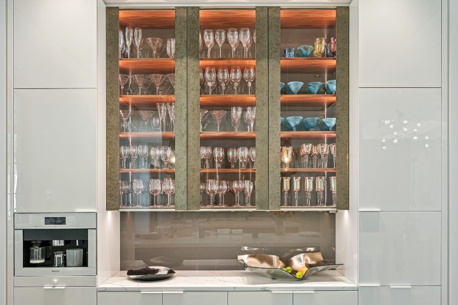 Close-up espresso bar area, glassware, in-cabinet accent lighting and under cabinet task lighting