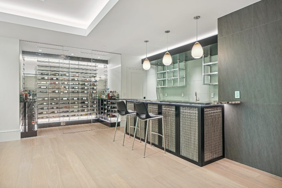Brightly lit wine room and bar area, pendant lighting and linear lighting overhead, Lutron controls, Atlantic Control Technologies contemporary estate