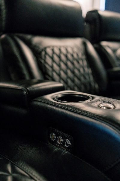 Closeup of black leather theater seating