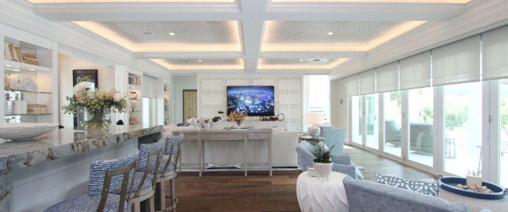 Geeks of Technology Crestron Home bright lights white colorations focus on wall mounted TV in the back