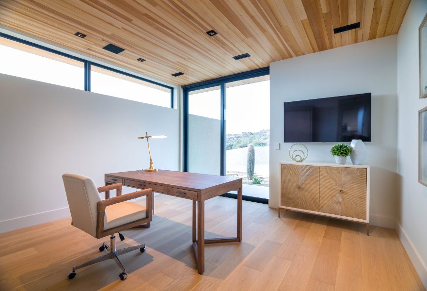 Home office brightly lit with overhead wooden panels looking out onto Arizona Desert, Phoenix