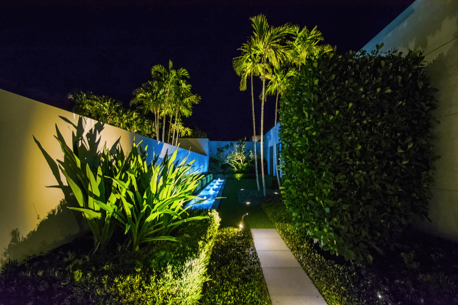 Small neatly trimmed alleyway with fountains and landscape lighting, ETC, integration, Florida