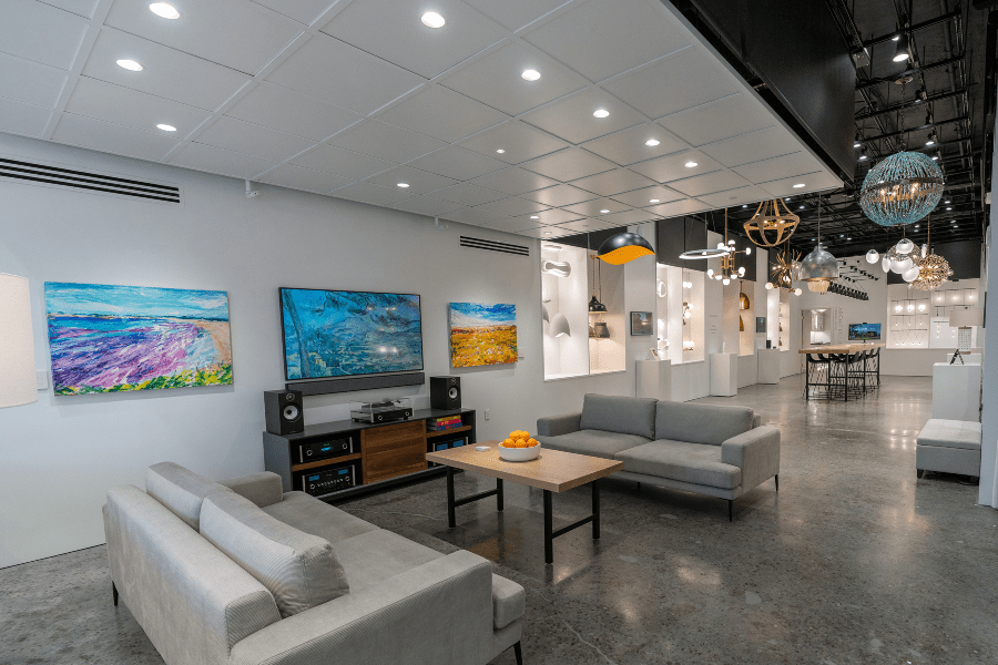 System 7 Experience center full showroom shot, extravagant luxury lighting fixtures in the background
