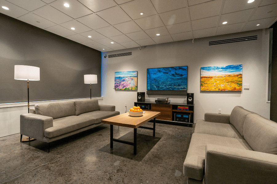 Living room setting, color tunable Ketra Lighting overhead, motorized shade walls, Samsung Frame TV